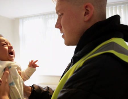 stressed dad holding crying baby