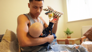 stressed dad holding and playing with baby