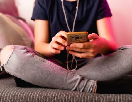 teenage girl holding mobile phone