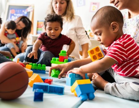 group of mothers with their babies sitting on the floor playing