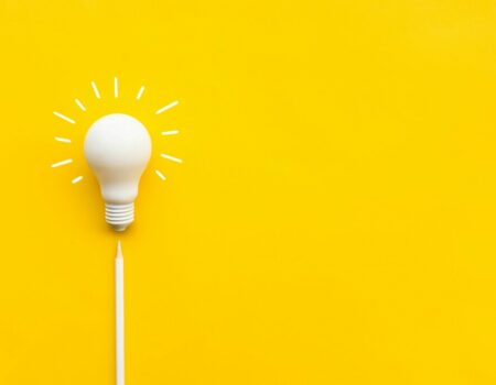lightbulb and pencil on yellow background