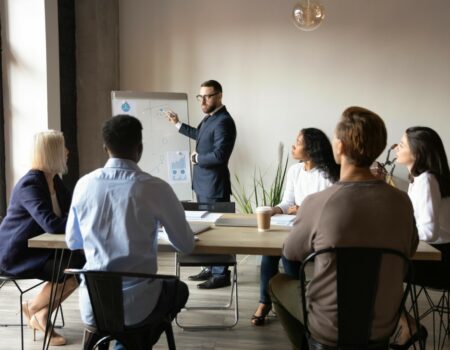 professional male teaching leading a presentation to a small group