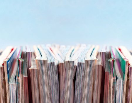 colourful row of books on light blue background